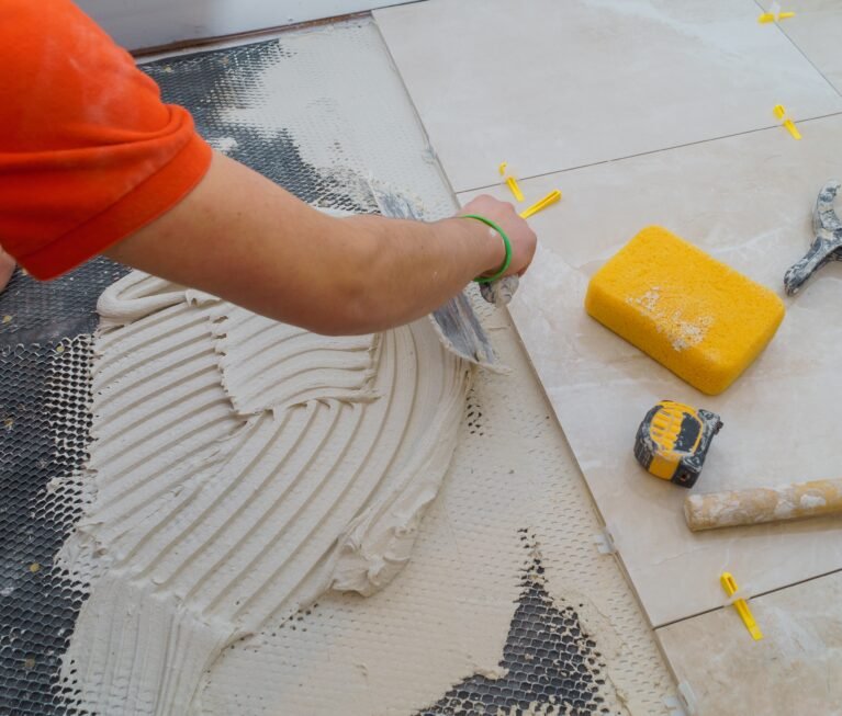 Applying new tiles on bathroom floor tile installation for house building
