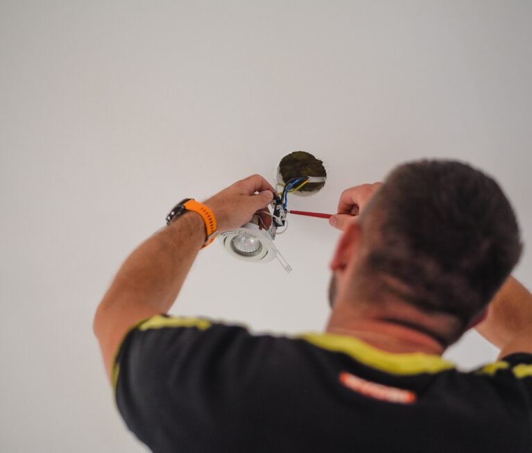 back-view-of-a-handyman-fixing-electricity-wires-i-2024-11-27-12-20-32-utc