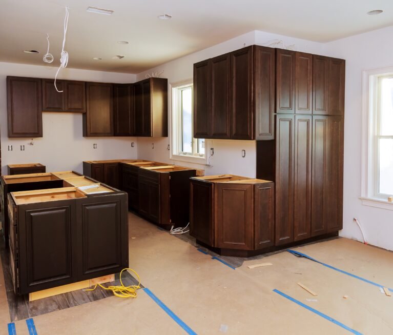 Custom kitchen cabinets in various stages of installation base for island in center