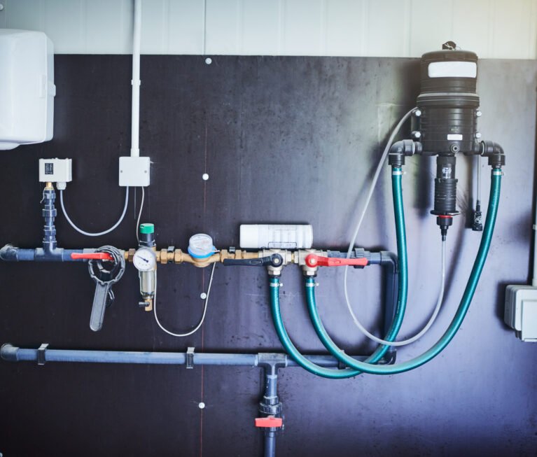 Everything has its place. Shot of equipment mounted against a wall in a factory