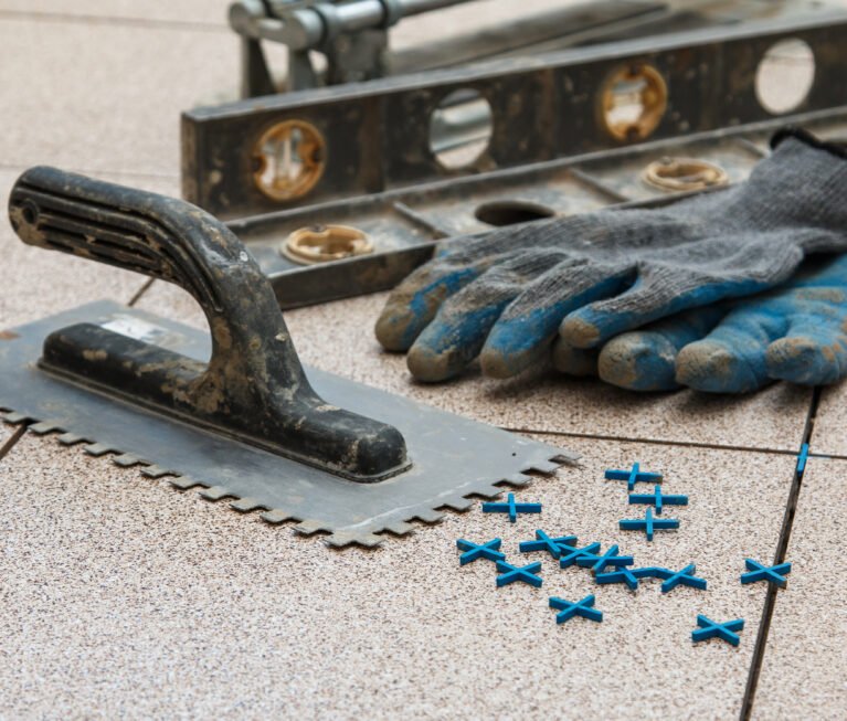 Installation of floor tiles. Ceramic tiles and different tools
