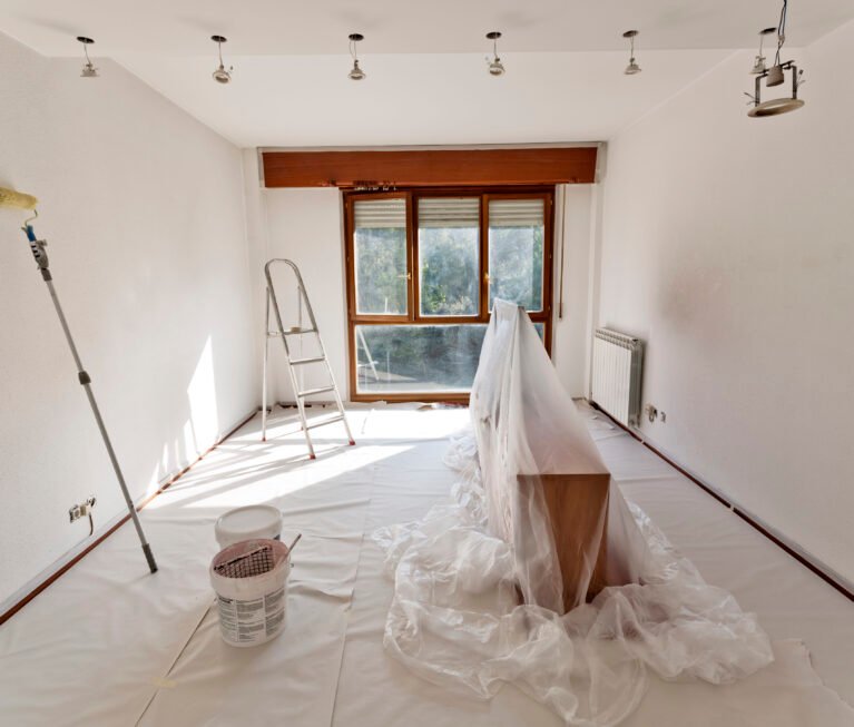 Painting tools an empty room, ready for renovation
