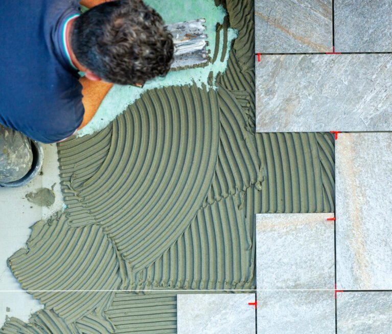 Spreading with trowel floor glue. View from above.